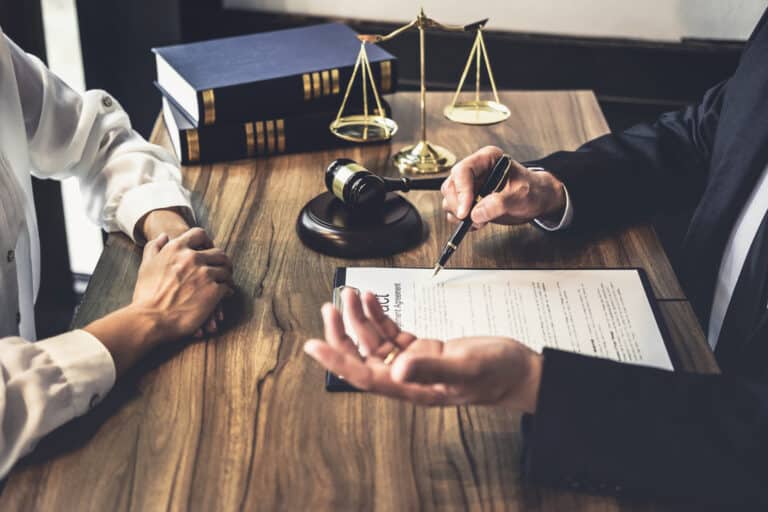 Attorney and the defendant discussing the case at the table.